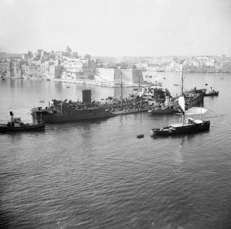Which tanker, being towed by small vessels, is shown entering Valletta's Grand Harbour in this August 1942 photograph?