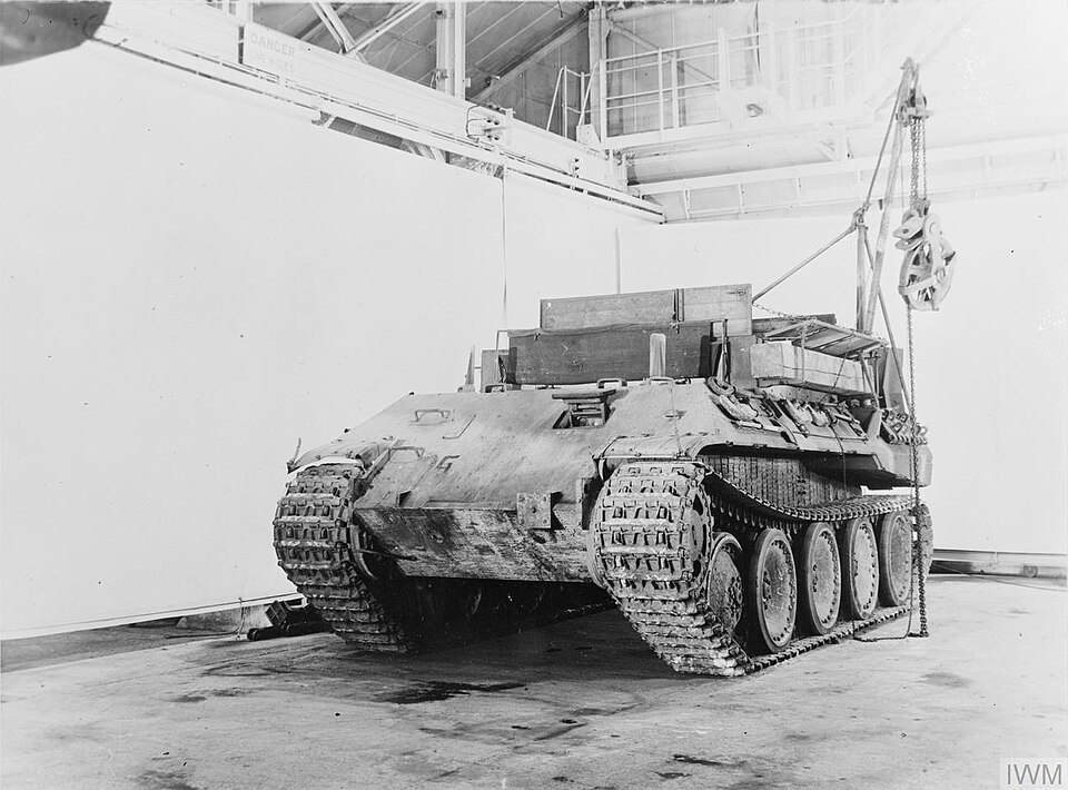 What type of vehicle is shown in the photograph, turretless and set up to lift heavy loads?